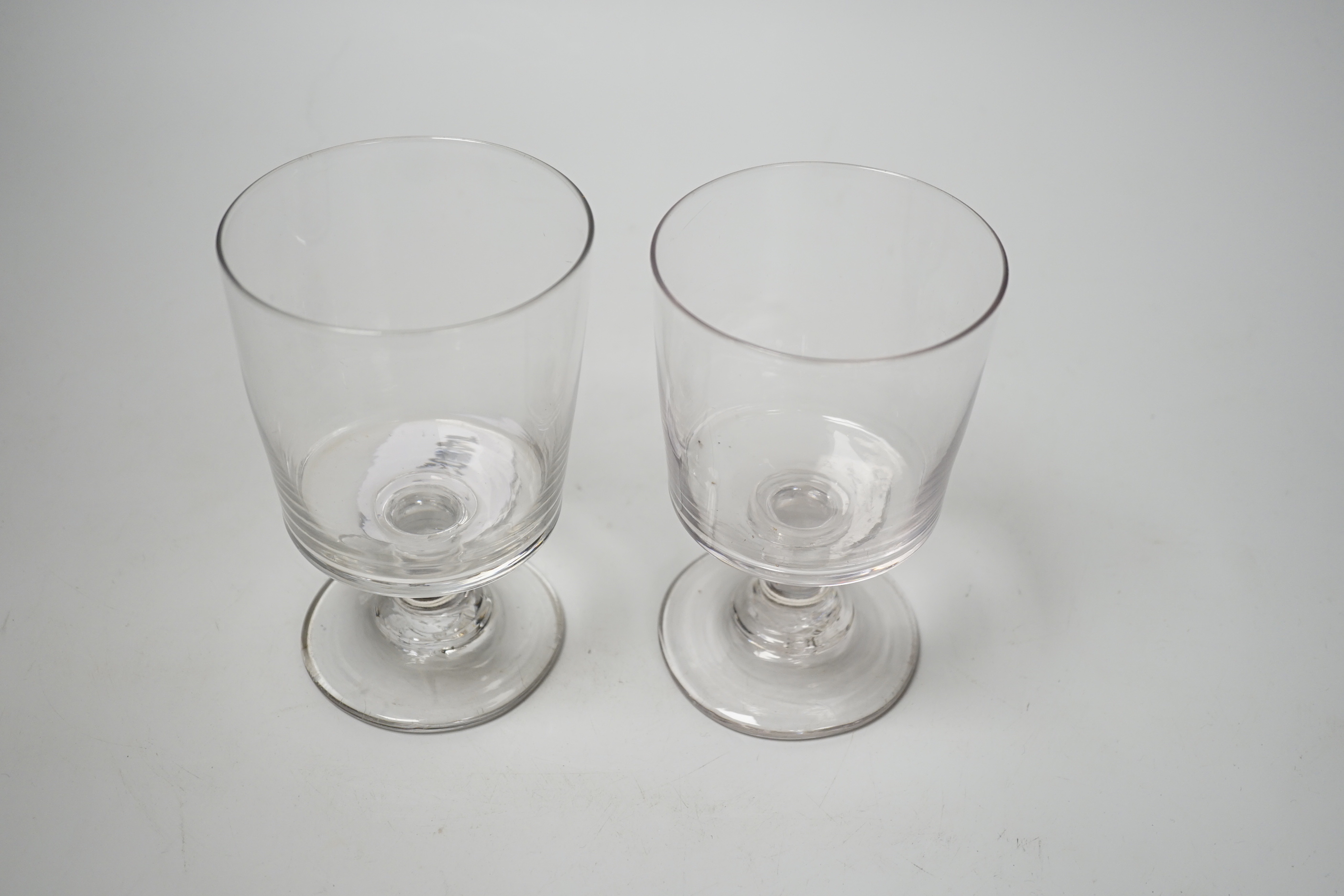 Two early 19th century English lead crystal rummers, in the form of square bucket shapes, with capstan stems and plain foot. 14.5cm highest